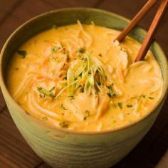 Thai Coconut Curry Soup - Chef Michael Smith Ingredients 2 cans (14-ounce/400 mL each)of premium coconut milk 1 heaping tablespoon (20 mL) of Thai curry paste the tender stems of 1 bunch of cilantro, rinsed well 2 chicken breasts, thinly sliced 2 cups (500 mL0 of chicken broth 1 carrot, shredded 4 or 5 lime leaves 2 stalks of lemon grass, halved lengthwise, woody leaves removed 2 tablespoons (30 mL) of fish sauce the zest and juice of 2 limes a small knob frozen ginger a handful bean sprouts a 8 ounce (225 g) package rice noodles 1 bunch of cilantro leaves, rinsed well 2 or 3 green onions, thinly sliced a sprinkle or two salt or soy sauce Procedure Scoop the thick coconut cream from the top of just one of the cans into a large stockpot set over a medium-high heat. Melt the cream, add the curry paste and stir for a few minutes until they begin to sizzle. Add the cilantro roots and chicken and sauté until the chicken is cooked through, about 5 minutes. Add the coconut juice from the first can and all the contents of the second can along with the chicken broth, carrot, lime leaves, lemon grass, fish sauce and lime zest and juice. Grate the frozen ginger into the broth with a Microplane grater or standard box grater. Simmer for 20 minutes or so. Stir in the bean sprouts. Add the rice noodles, gently pushing them beneath the surface of the broth. Turn off the heat and let stand until the noodles soften, about 5 minutes. Rice noodles don’t need to simmer like pasta to cook; they simply need to rehydrate in the hot liquid. Stir in most of the cilantro leaves. Remove the lemon grass stalks. Taste and season with a touch more salt (or soy sauce) as needed. Ladle into large bowls and garnish with the green onions and remaining cilantro leaves.