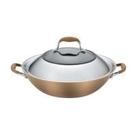With generous size and a unique lid, the Anolon Advanced Bronze Hard-Anodized Nonstick 14-Inch Covered Wok offers ample room to toss and stir vegetables, tofu and meats to create delicious Asian-inspired meals. The wok's heavy-duty, hard-anodized construction provides even heat distribution for exceptional cooking performance, and the distinctive bronze exterior and rich chocolate interior add elegant design. PFOA-free restaurant-tested DuPontTM AutographTM 2 nonstick is metal utensil safe and ideal for easy cleanup inside and out, with superior durability. The wok's lid is constructed with a wide, mirror-polished stainless steel rim that helps bean sprouts, vegetables, and more cook and steam faster and more efficiently. And the convenient, shatter-resistant glass in the center of the lid enables the cooking to be monitored and keep heat and moisture inside. The lid and wok feature revolutionary rubberized stainless steel Anolon SureGrip handles for a confident, comfortable grasp when stirring, tossing, and plating. All of the handles are dual-riveted for extra strength and oven safe to 400F, and this covered wok works well with many pieces in the Anolon Advanced Bronze collection.