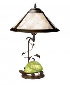 Metal base in antique bronze paint Table lamp in Tiffany style Empire shaped lamp in mica shade Requires (1) 60-watt E27 and (1) 15-watt E12 bulbs (not included) Dimensions: 14.75L x 14.75W x 22.75H inches A metal turtle with a bright green art glass shell rests at the base of the Dale Tiffany Mica Green Turtle Table Lamp, adding a touch of whimsy to your living room. Finished in antique bronze paint, this table lamp has a gorgeous empire-shaped mica shade. It uses one 60-watt bulb for the main fixture and one 15-watt bulb for the turtle's shell (bulbs not included). About Dale Tiffany Founded in 1979, Dale Tiffany, Inc. started manufacturing Tiffany-styled lamps and shades, emphasizing high-quality reproductions of Louis Comfort Tiffany's famous designs. Today, using only the highest quality genuine hand-rolled art glass, Dale Tiffany offers an extensive range of designs to comprise the world's foremost collection of fine art glass lighting and home accents. With this hand-crafted process, no two pieces are exactly alike, making each design a treasured keepsake. Dale Tiffany captures the timelessness of America's classic designers while developing unique designs that blend perfectly with today's home fashion trends and lifestyles.